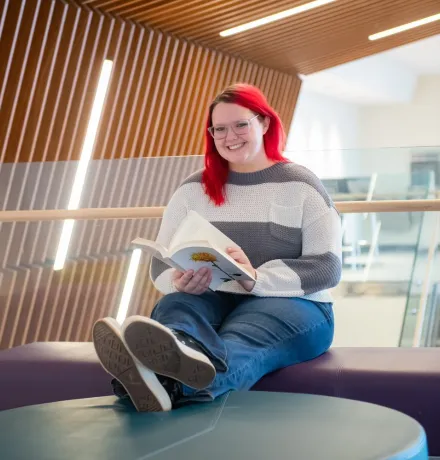 a UPEI student in the Performing Arts Centre and Residence foyer