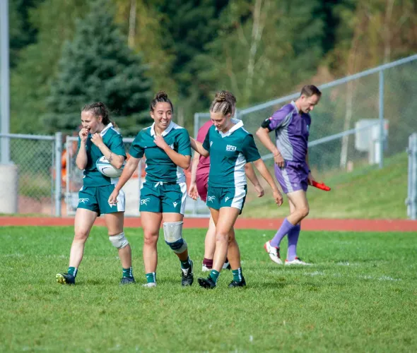 Three UPEI rugby athletes on the field 